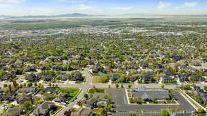 Aerial overview of property's location with a mountain backdrop and nearby suburban area