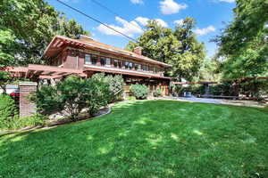 Rear view of house with a lawn and a chimney