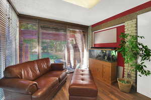 Living room featuring a textured ceiling and wood finished floors