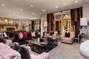 Living room featuring recessed lighting, carpet floors, and a fireplace