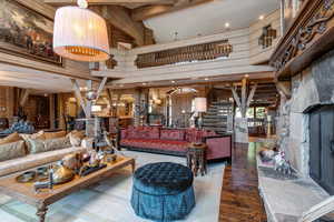 Building lobby with beamed ceiling, stairs, wood walls, high vaulted ceiling, and recessed lighting