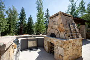 View of patio / terrace with a fireplace and area for grilling