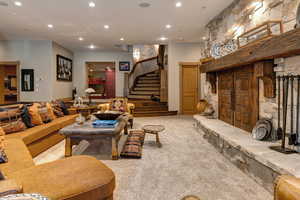 Living area featuring carpet floors, stairway, and recessed lighting