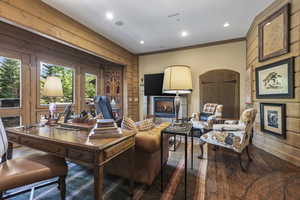 Living area featuring crown molding, a lit fireplace, and recessed lighting