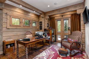 Office area featuring hardwood / wood-style floors, wood walls, and french doors
