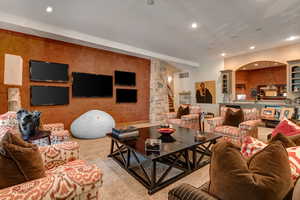 Living area featuring recessed lighting and stairs