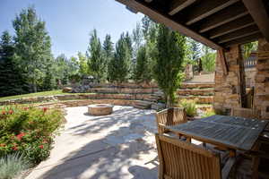 View of patio / terrace with outdoor dining space and a fire pit