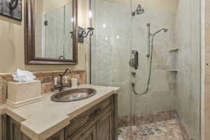 Bathroom featuring a stall shower and vanity