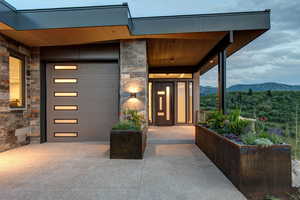 Property entrance with stone siding and a mountain view