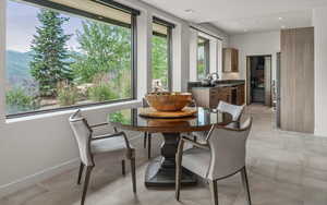 Dining room featuring a mountain view, recessed lighting, and light tile patterned floors