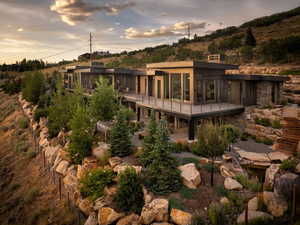 Back of house featuring a balcony and a patio