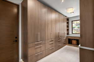Walk in closet with light tile patterned floors
