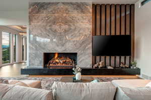 Living area with a high end fireplace and wood finished floors