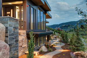 View of side of property featuring a balcony and a mountain view