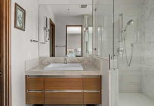 Ensuite bathroom featuring vanity and a stall shower