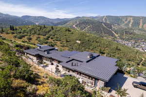 Aerial view of property and surrounding area with mountains