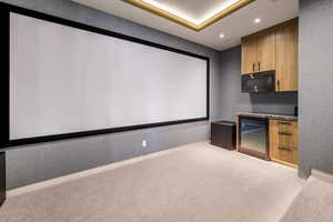 Cinema featuring wine cooler, carpet flooring, and recessed lighting