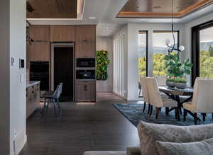 Dining space featuring a tray ceiling, a chandelier, wood ceiling, and recessed lighting