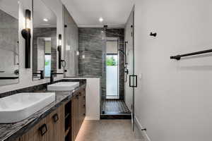 Full bath featuring double vanity, tile patterned flooring, a shower stall, and recessed lighting