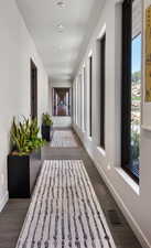 Hallway with recessed lighting and dark wood finished floors