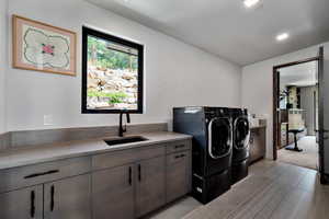 Laundry area with washer and clothes dryer, cabinet space, and recessed lighting