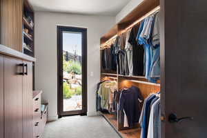 Walk in closet featuring carpet flooring