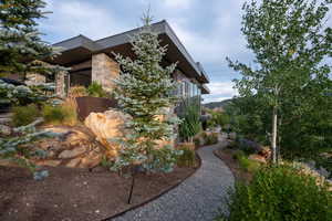 View of side of home featuring stone siding