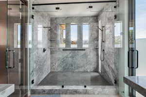 Full bath featuring a marble finish shower