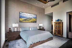 Bedroom featuring a towering ceiling, wallpapered walls, recessed lighting, and an accent wall