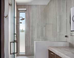 Full bathroom featuring a walk in shower and vanity