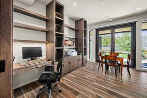 Home office featuring dark wood-type flooring, recessed lighting, and built in study area