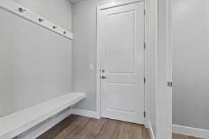 Mudroom with light wood finished floors and baseboards
