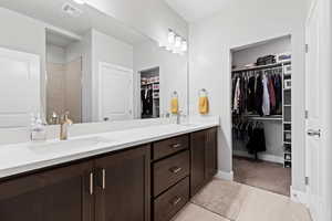 Bathroom featuring light tile patterned floors and a spacious closet