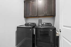 Laundry area featuring cabinet space and washer and dryer
