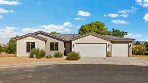 Single story home featuring a tiled roof, a garage, concrete driveway, and stone siding