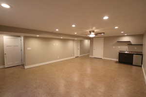 Finished basement featuring recessed lighting, ceiling fan, and bar with sink