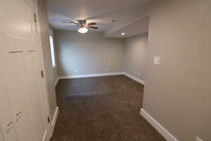 Unfurnished room with dark colored carpet, a ceiling fan, and recessed lighting