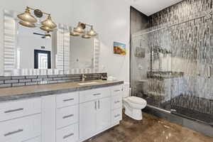 Full bath featuring a stall shower and vanity