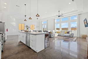Kitchen with white cabinetry, open floor plan, pendant lighting, plenty of natural light, and recessed lighting