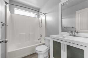 Bathroom featuring vanity, tub / shower combination, and tile patterned floors