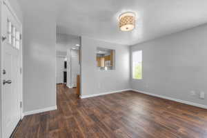 Foyer entrance featuring dark wood-style floors, a textured ceiling, and recessed lighting