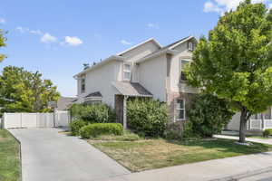 View of front of home with brick siding and stucco siding