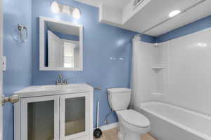 Bathroom with vanity, shower / tub combo, and tile patterned flooring
