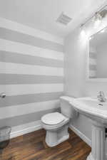 Bathroom with a textured ceiling and wood finished floors