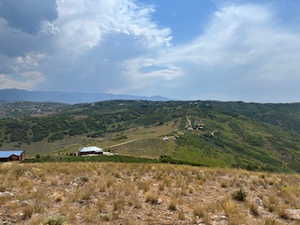 View of mountain backdrop with rural landscape