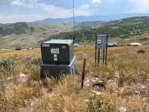 Exterior view of a mountainous background and a pad mount transformer
