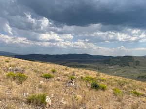 View of mountain backdrop featuring rural landscape