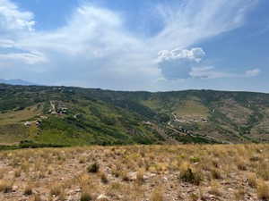 View of mountain background featuring rural landscape