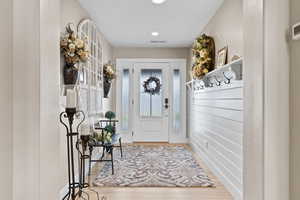 Mudroom with light wood-type flooring and recessed lighting