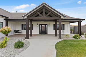 Entrance to property featuring a porch and a shingled roof